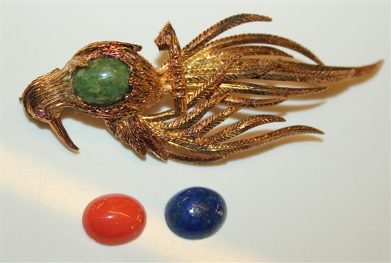 A 14k gold bird brooch with interchangeable stones.